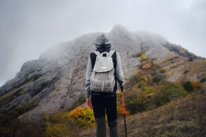 Asian woman stands by the mountain. Cold weather